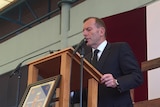 Tony Abbott reads from the Bible during a Good Friday service