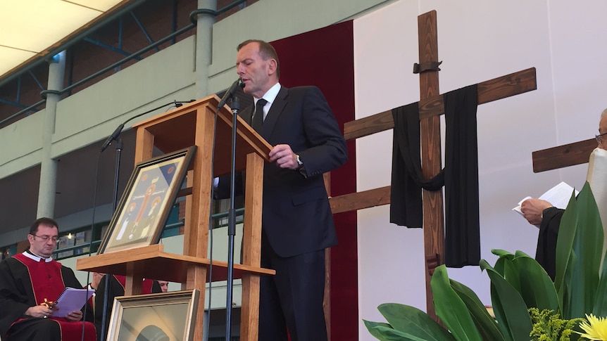 Tony Abbott reads from the Bible during a Good Friday service