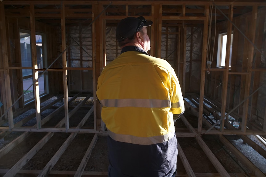 A man looking over repair works in a famiy unit