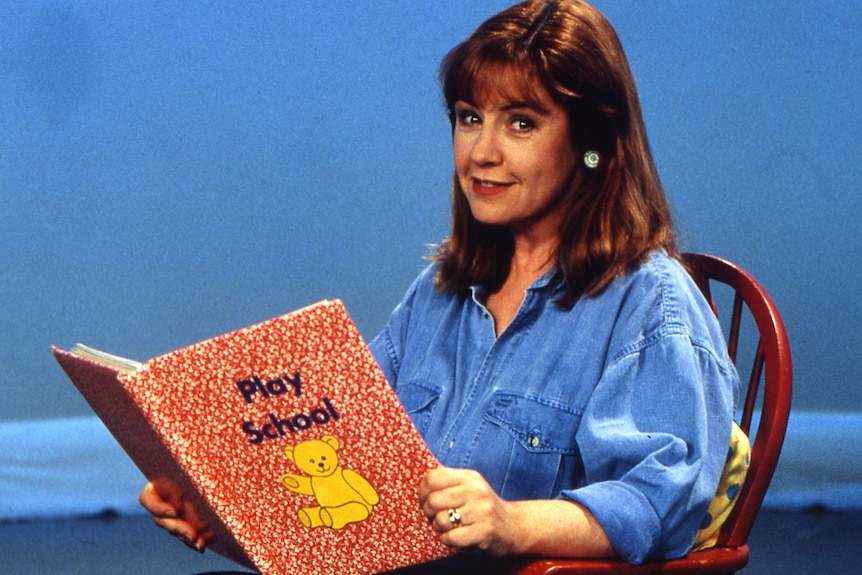 a young noni hazlehurst reading a play school book on the set of the children's show 