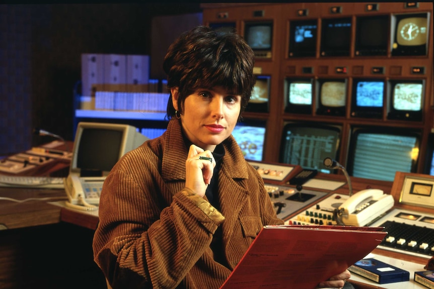 Archival photo of ABC staffer Stephanie Lewis sits near a television control panel