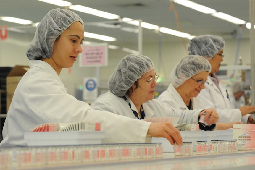 Workers in a factory wearing fish nets on their heads