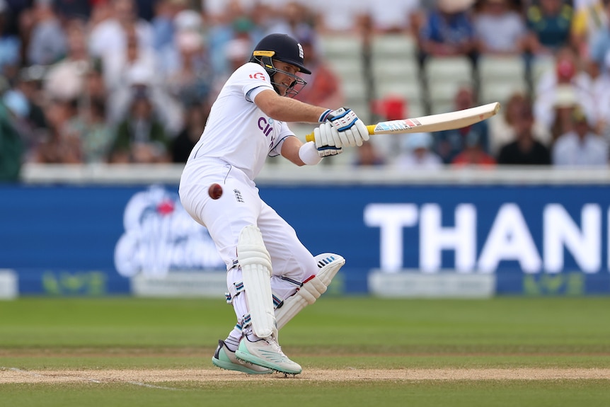A cricket ball goes past England batter Joe Root as he plays an awkward shot in the Ashes.