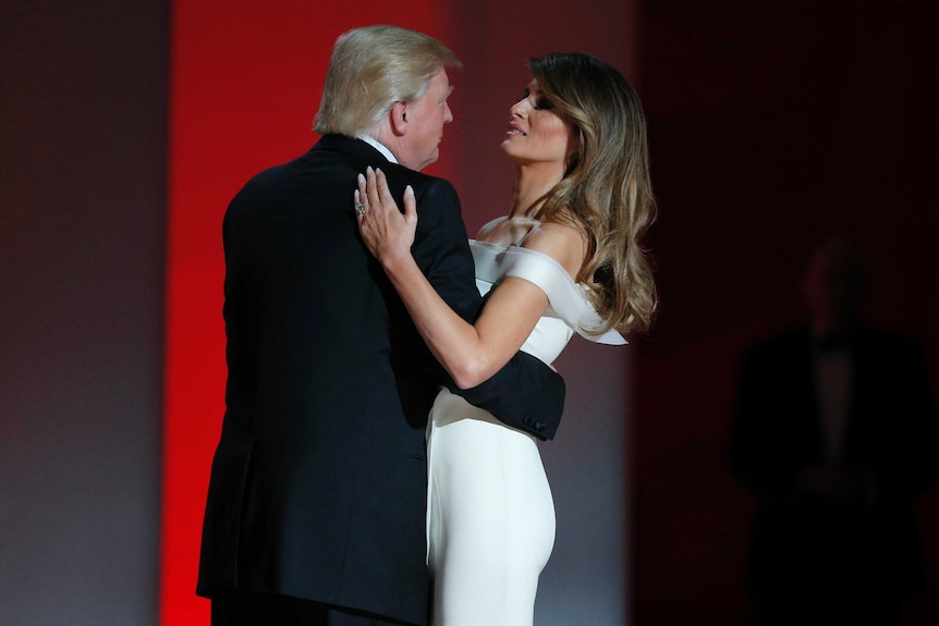 Donald Trump and Melania Trump embrace each other in a dance