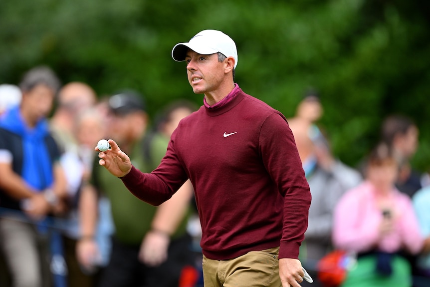 Rory McIlroy holds a ball