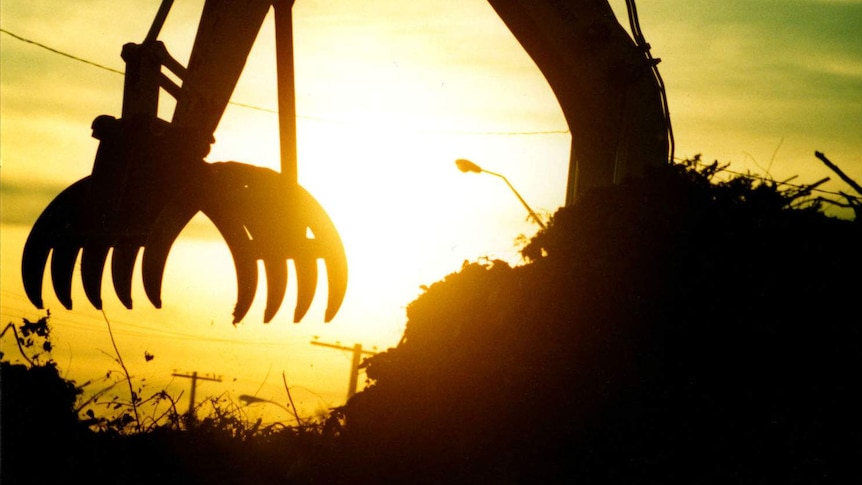 A digger with its claw open.