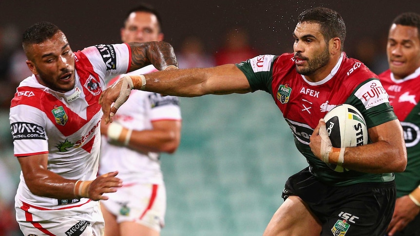 Greg Inglis shrugs off the Dragons defence