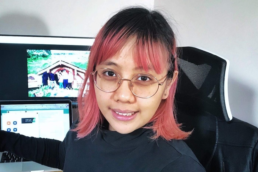 A woman with red and black hair up close