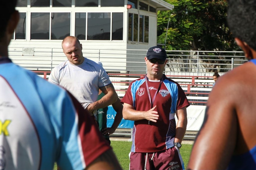 two men in sports gear facing camera and two men with back to camera