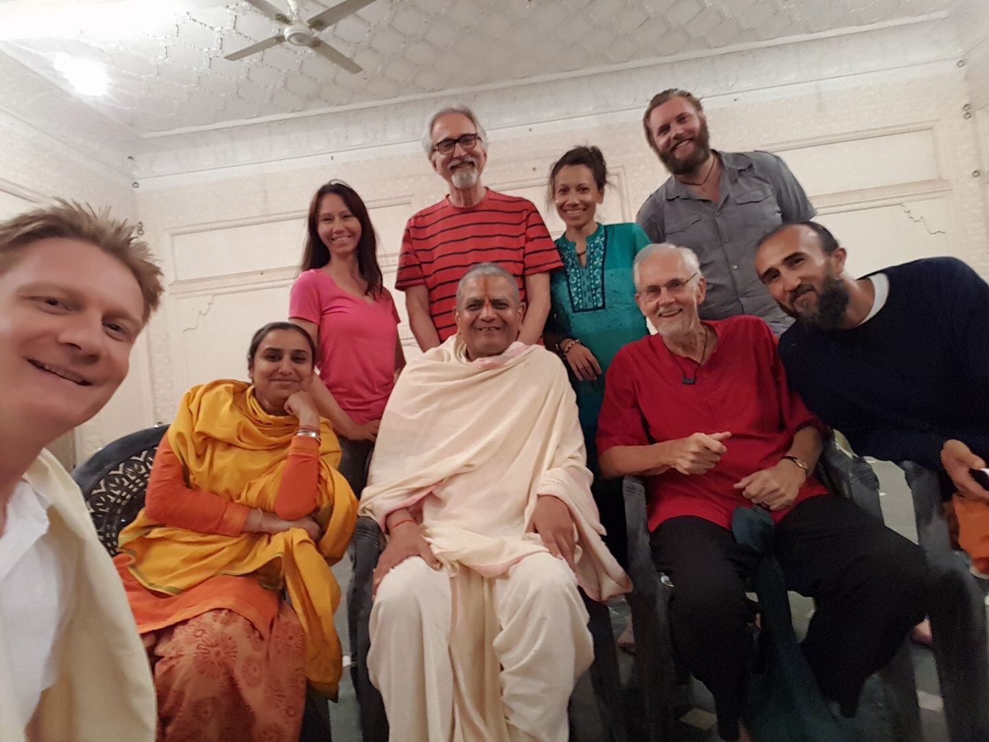 A group of multi-faith people smiling at the camera.