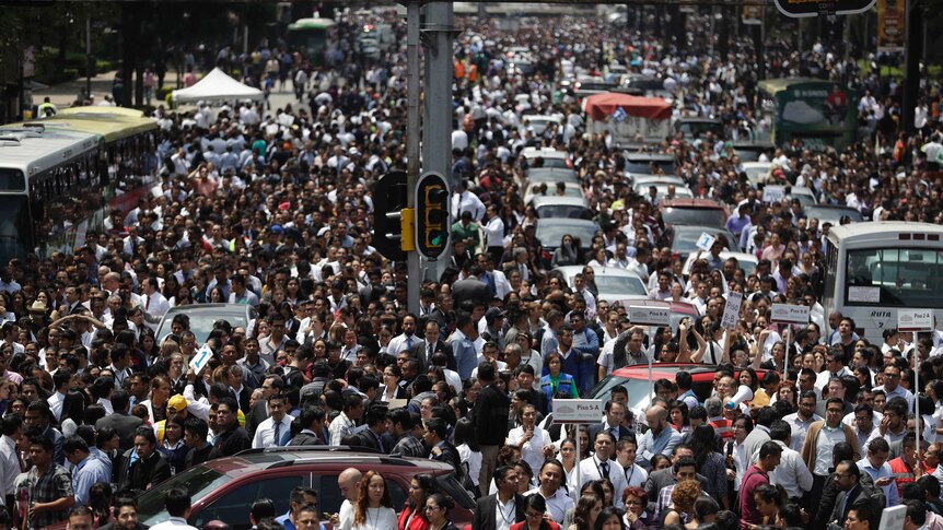 People pack a street after an earthquake.