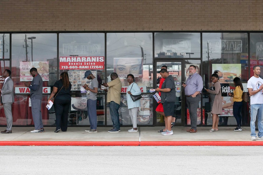 Voters wait in the line to vote at the Fiesta Mart on Election Day in Houston.