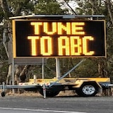 Electronic sign on trailer saying Tune To ABC.