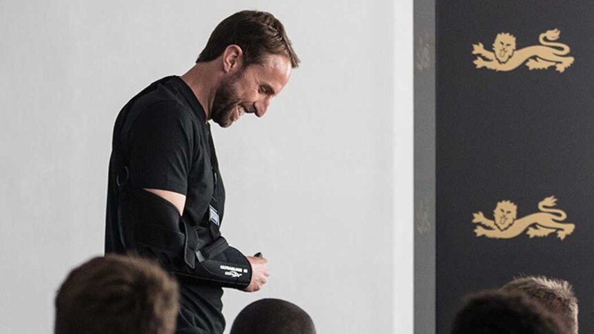 England manager Gareth Southgate with his arm in a sling at a World Cup team meeting.