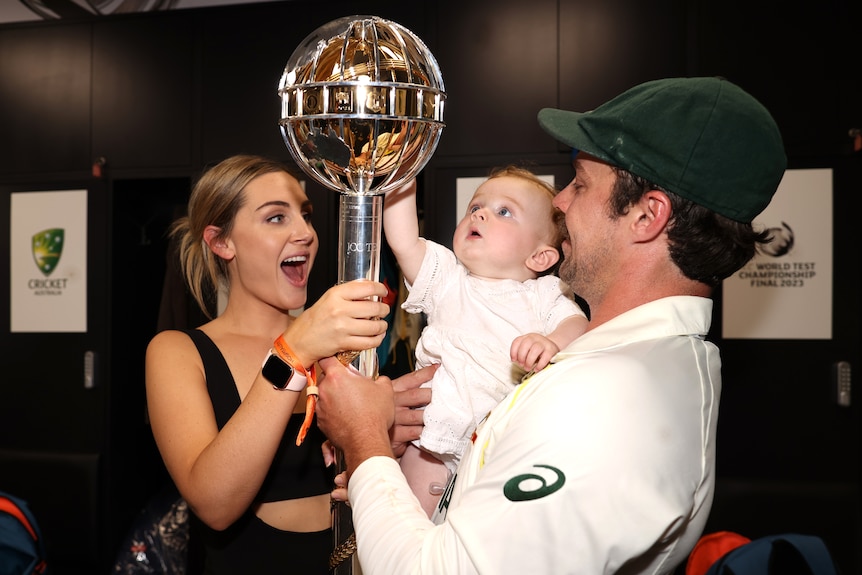 Travis Head, wife Jess and their child Milla hold the World Test Championship Mace