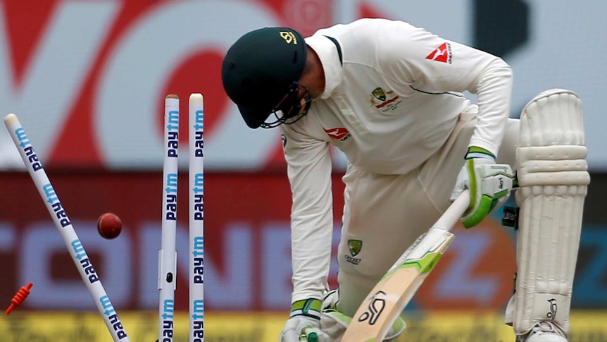 Peter Handscomb looks back at his stumps after being dismissed