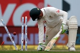 Peter Handscomb looks back at his stumps after being dismissed