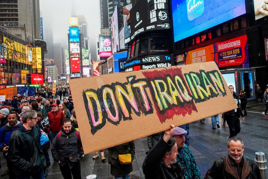 A sign reads "don't Iraq Iran" as protesters take part in anti-war protest in a crowded Times Square