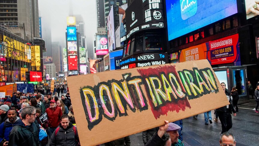 A sign reads "don't Iraq Iran" as protesters take part in anti-war protest in a crowded Times Square
