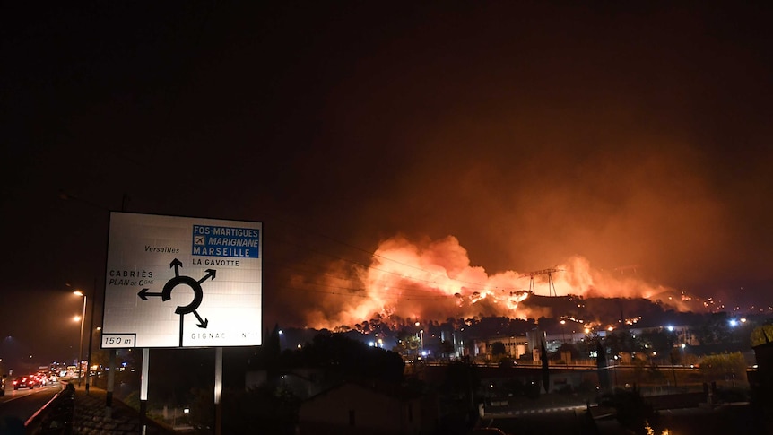 A fire rages on a hillside in southern France.