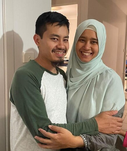 Raidah (right) and her brother (left) hugging.