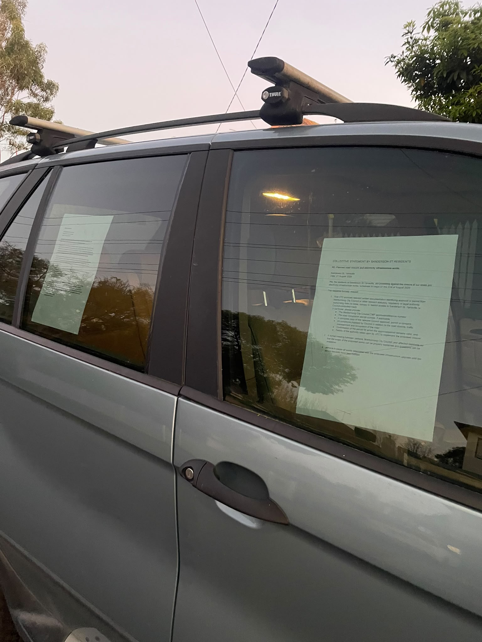 Two letters on the window of a car. 
