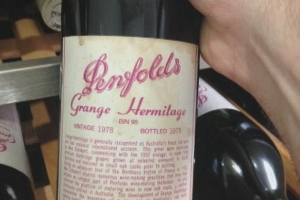 Queensland police seize one of 124 bottles of Grange Hermitage wine, which they say were the proceeds of crime.