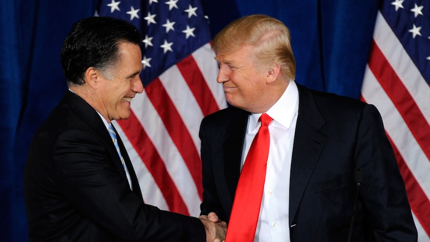 Mitt Romney shakes Donald Trump's hand.
