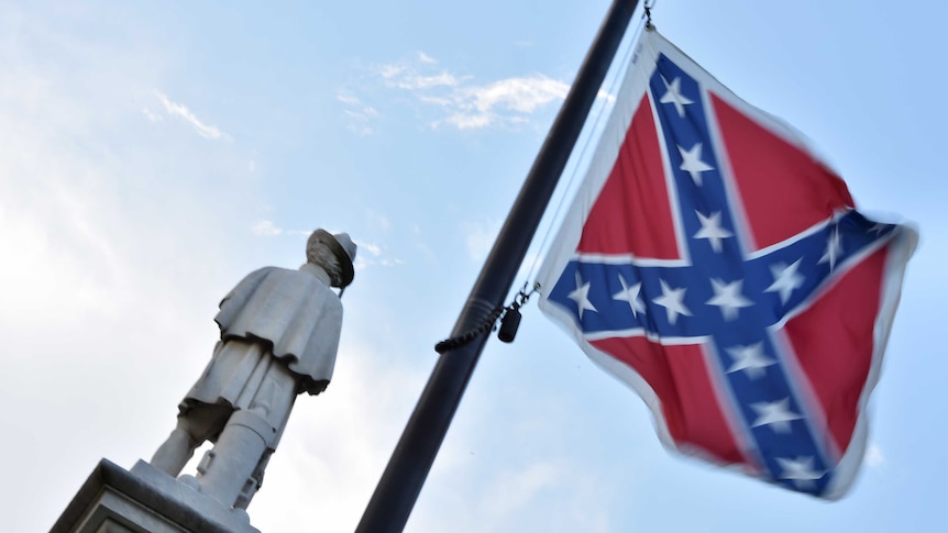 The Confederate flag is seen next to the monument of the victims of the Civil War in Columbia, South Carolina