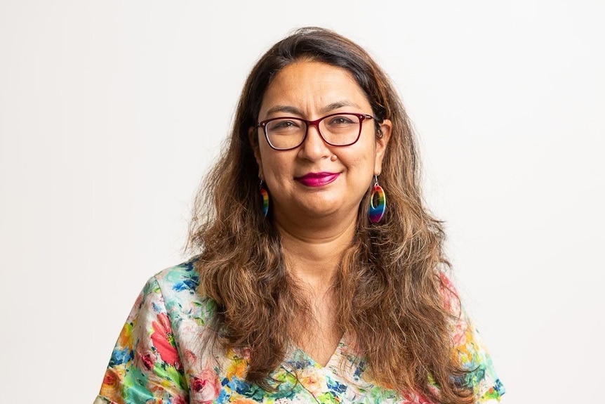 woman smiling in a colourful shirt