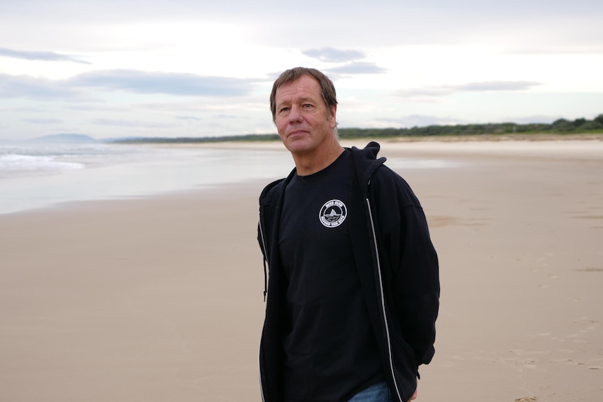 Dave Pearson walks on a beach
