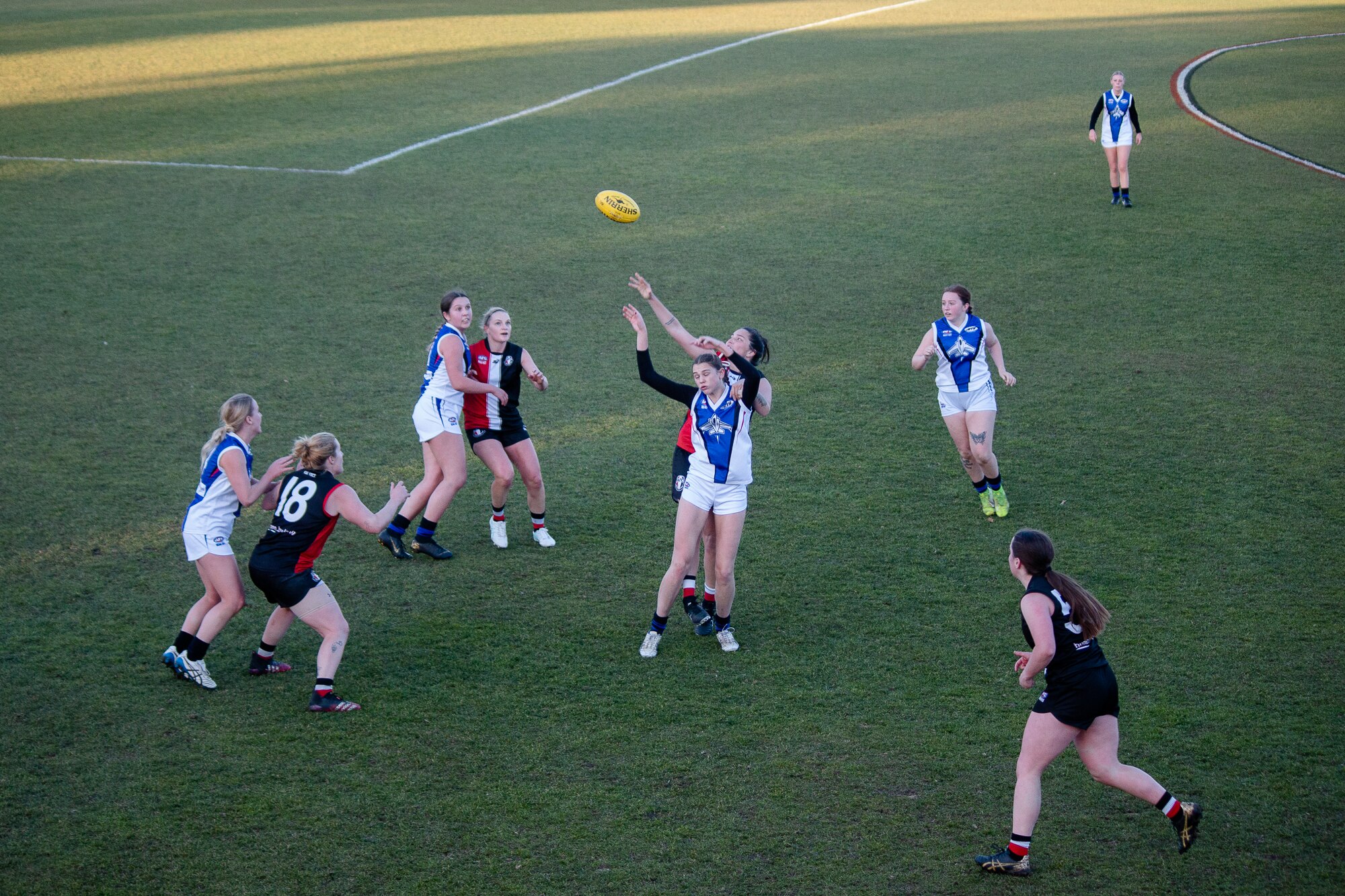 Women play Aussie rules.