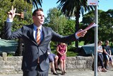 Toby Llewellyn, a 29-year-old auctioneer with Cooley Auctions in Sydney, about to close a sale in front of a house for auction