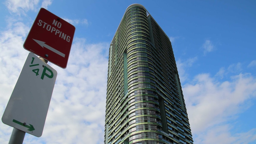 The Opal Tower with a sign to the left