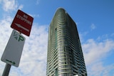 The Opal Tower with a sign to the left