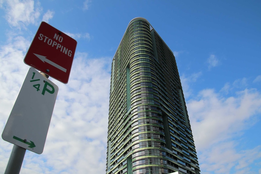 The Opal Tower with a sign to the left