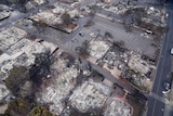 An aerial photo showing a town where all the buildings have been destroyed by fire.
