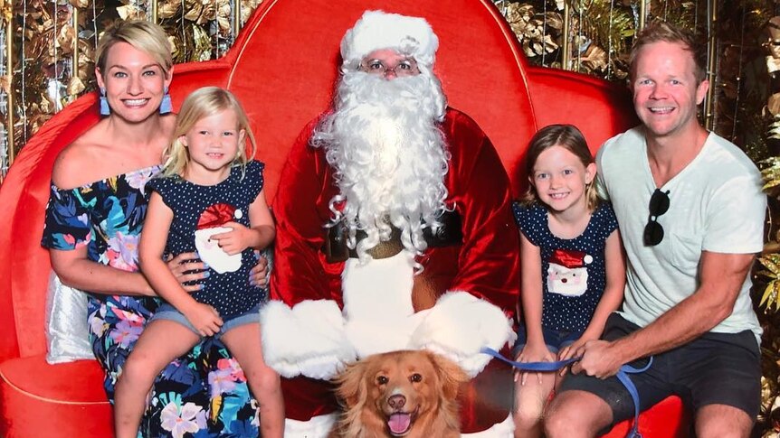 Burleigh Heads mother Emma Laing posing with her family at their annual Santa photo