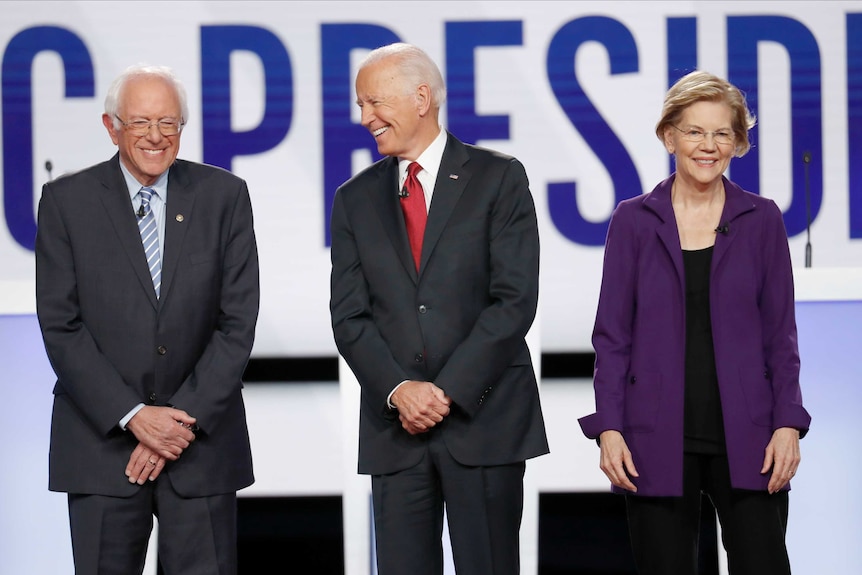 Bernie Sanders, Joe Biden and Elizabeth Warren smile.
