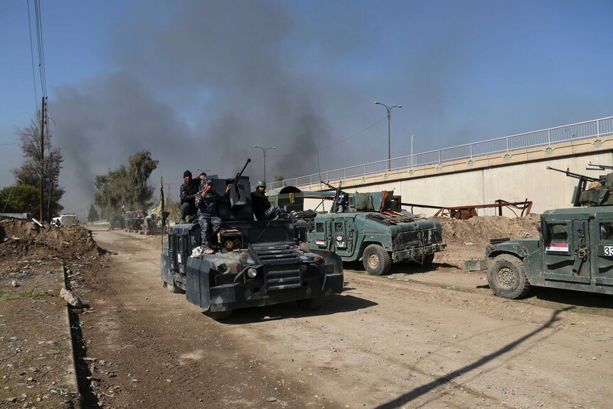 Iraqi security forces advance during fighting against Islamic State militants in Mosul.
