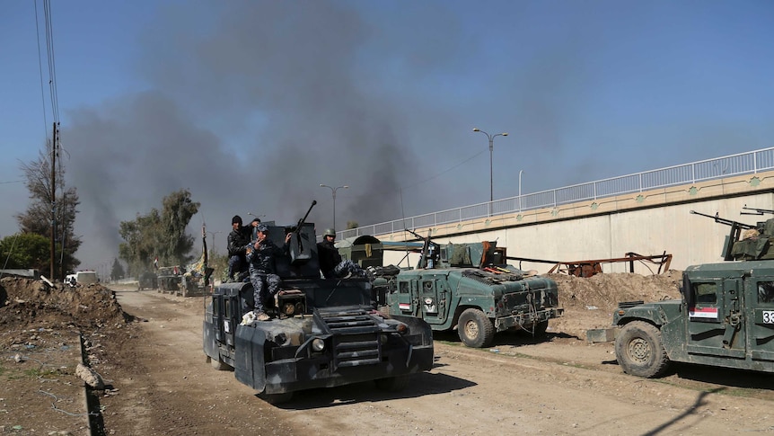 Iraqi security forces advance during fighting against Islamic State militants in Mosul.