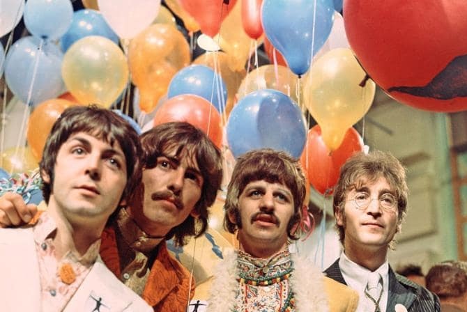 The Beatles pose in front of some colourful balloons around the time of the Sgt Pepper's album