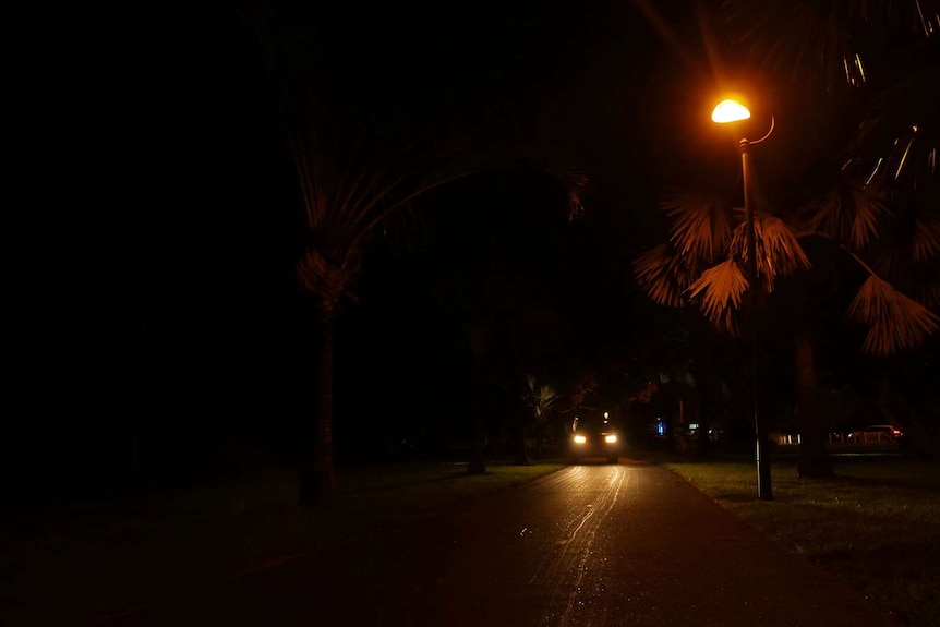 A photo of a distant car approaching with its headlights on.