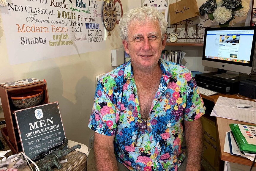 Ray Alexander sits in his wife's Townsville gift shop.