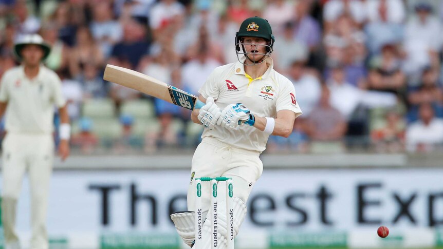 Australia batsman Steve Smith turns around with a vacant expression on his face as a cricket ball ricochets off his head.