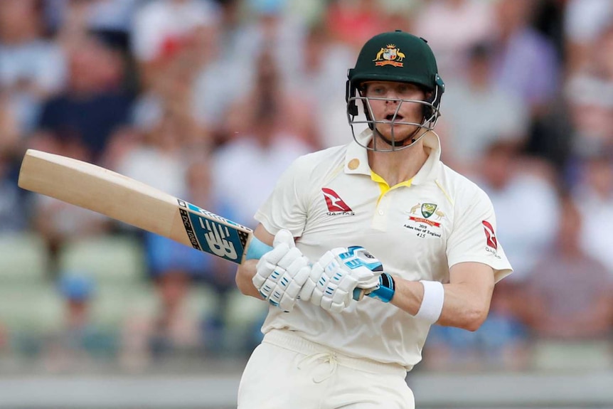 Australia batsman Steve Smith turns around with a vacant expression on his face as a cricket ball ricochets off his head.