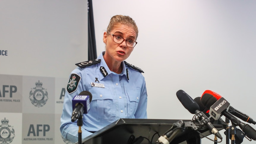 NSW Police Assistant Commissioner Justine Gough standing behind a podium with microphones speaking