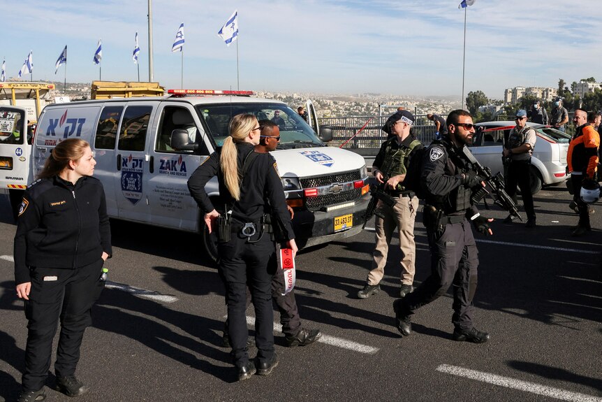 Israeli officials work at the scene of a violent incident in Jerusalem