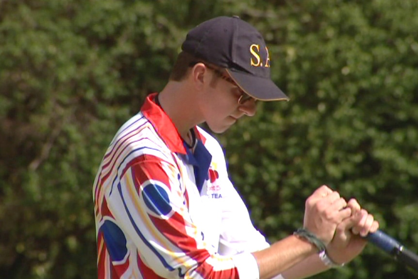 Young croquet player Edward Wilson plays a shot.