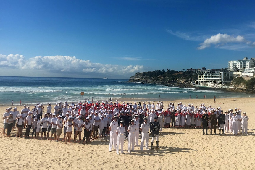 Hundreds of people on Bondi Beach in the shape of Australia.